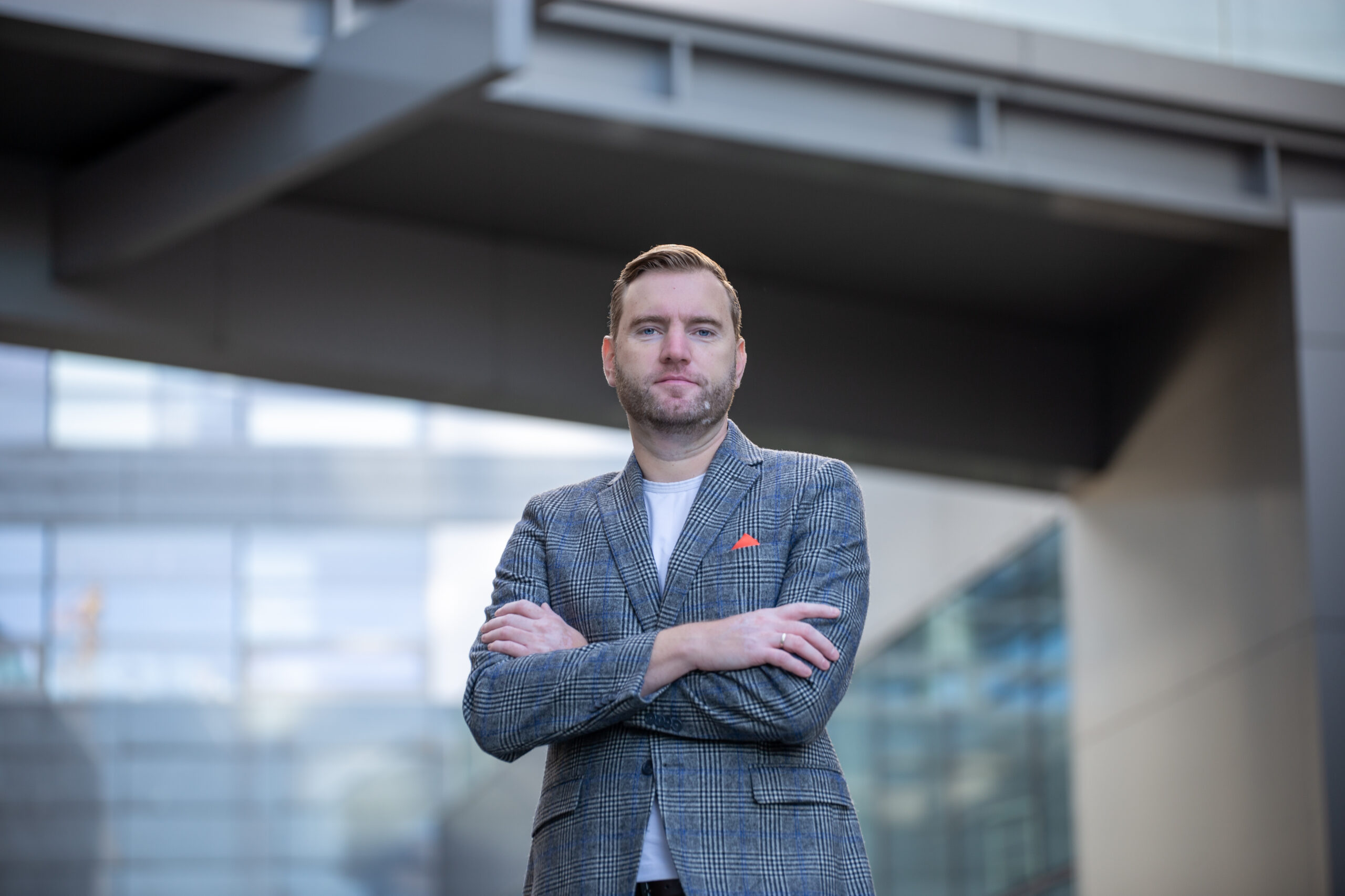 Man in blazer standing confidently outdoors