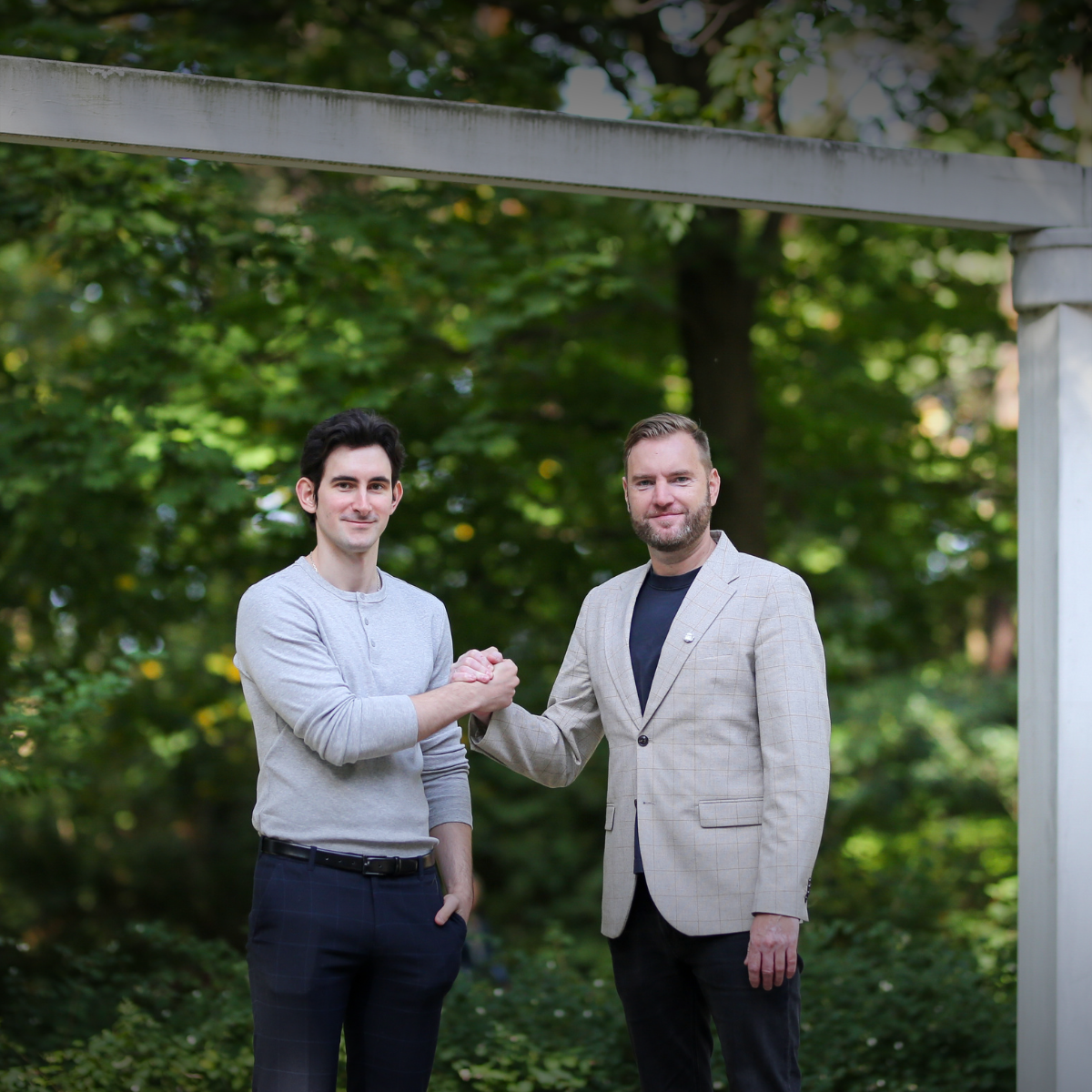 Two men shaking hands outdoors
